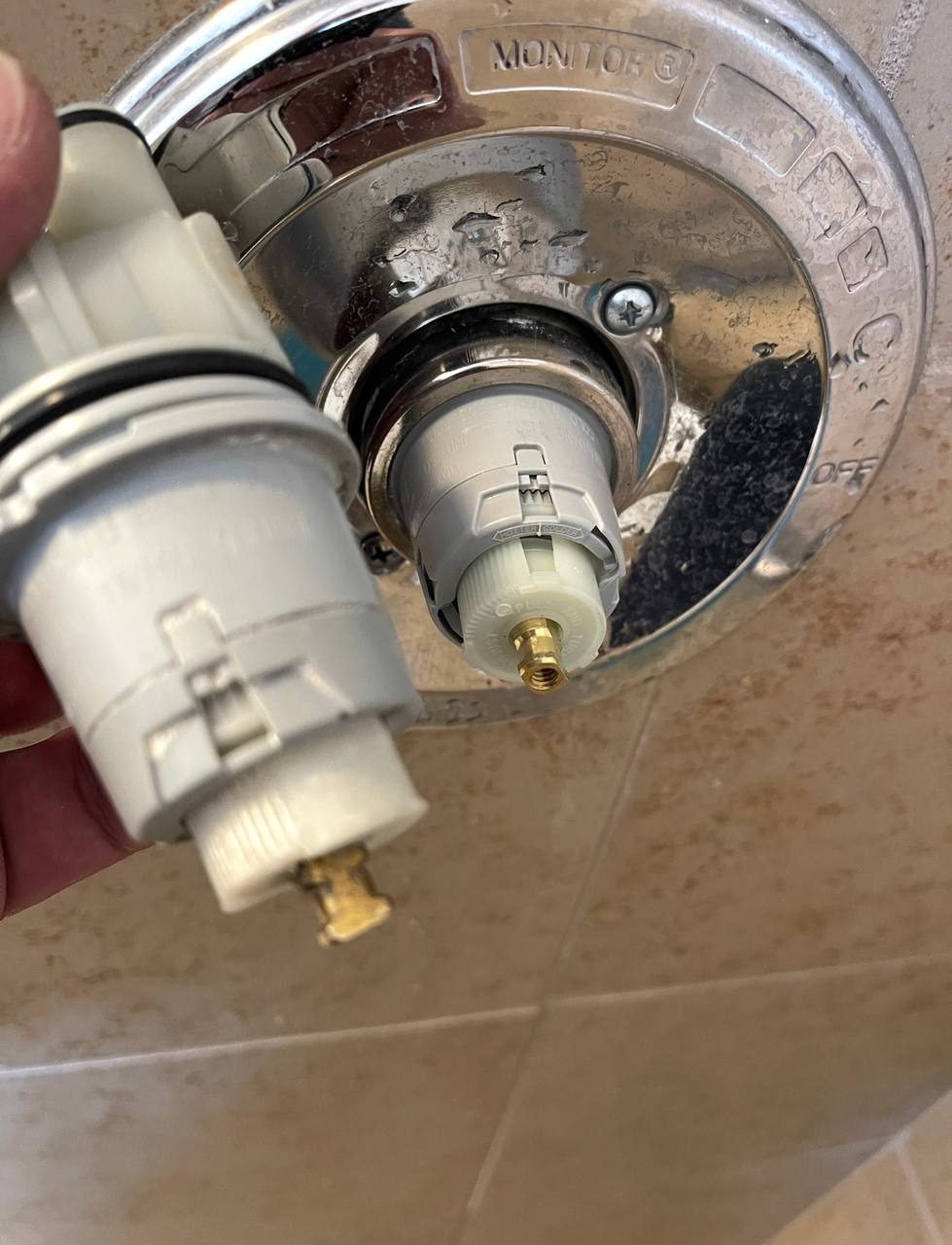 Shower cartridge exposed with the handle removed during repair